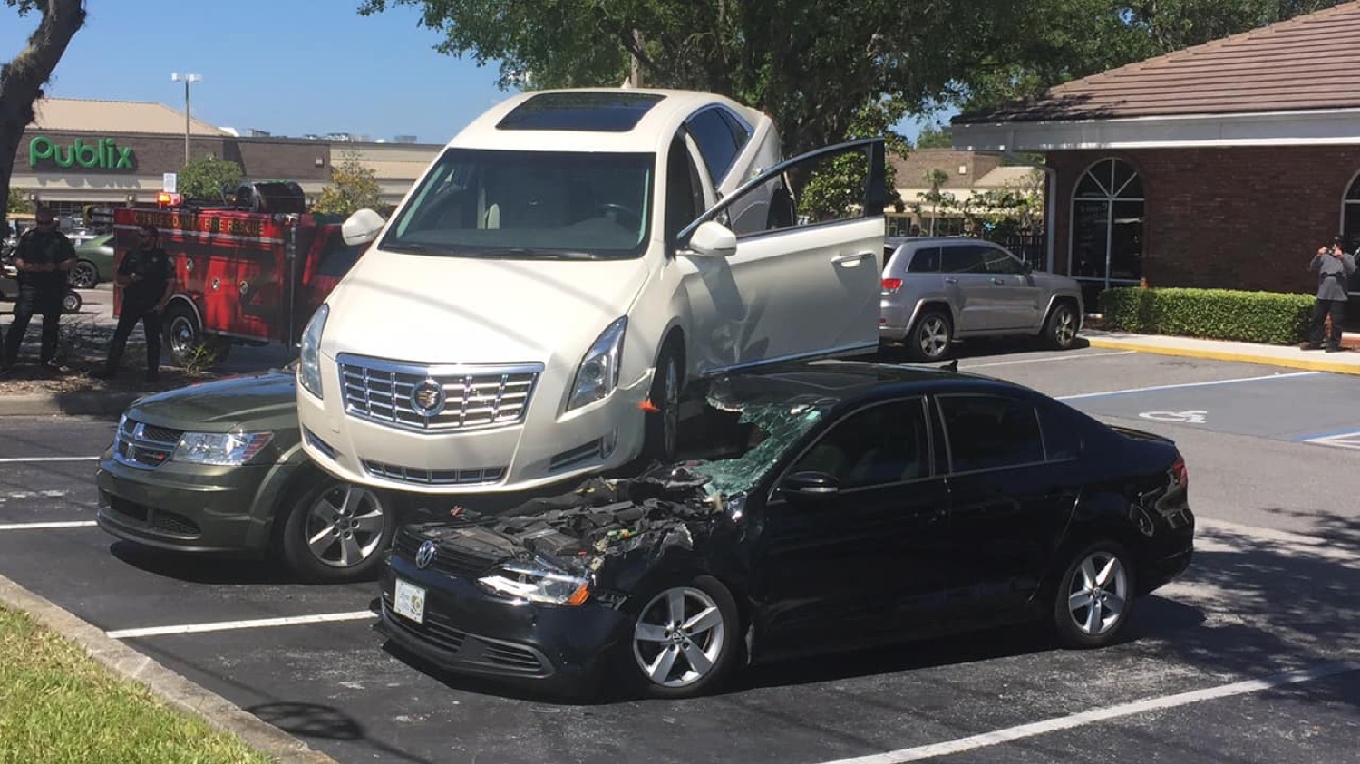 Cadillac XTS Reverses Through Intersection And Onto Parked Cars: Video